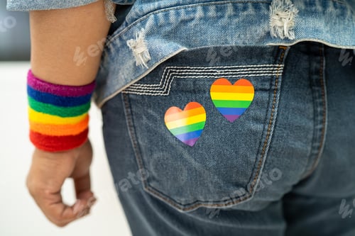 Preview: Asian lady with rainbow flag heart, symbol of LGBT pride month celebrate annual in June social