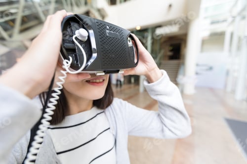 Preview: Young Woman looking with VR device