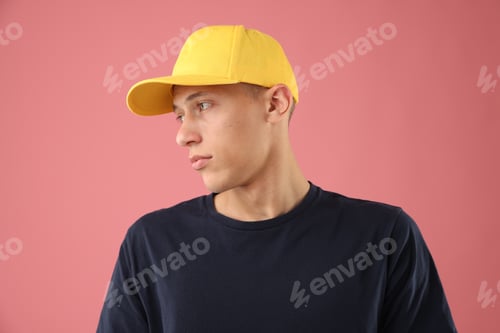 Preview: Young man in stylish baseball hat on pink background