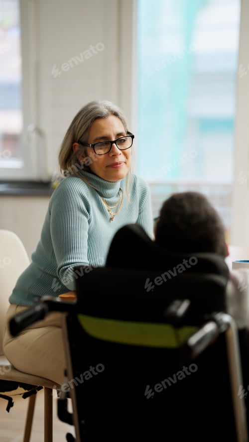 Preview: Woman communicating with person using a mobility aid
