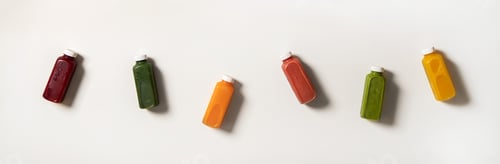 Preview: Flat-lay of fresh natural colorful organic juices in bottles
