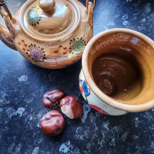 Preview: Teapot, Mug and Chestnuts on Dark Countertop