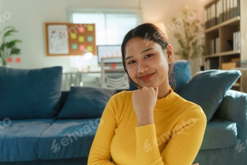 Preview: Young Asian Freelancer Woman Smiling and Relaxing on the Floor in her Home Office