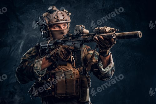 Preview: Special forces soldier in camouflage uniform holding an assault rifle with a laser sight