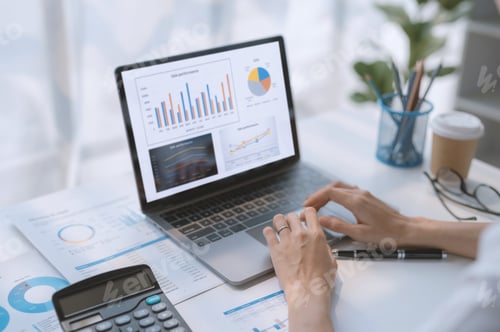 Preview: Woman working on laptop computer with graphs, charts, diagrams on monitor.