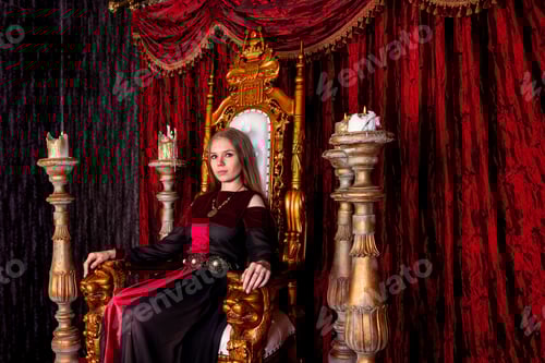 Preview: Lovely lady in an old style on antique throne fortress, looking at camera.