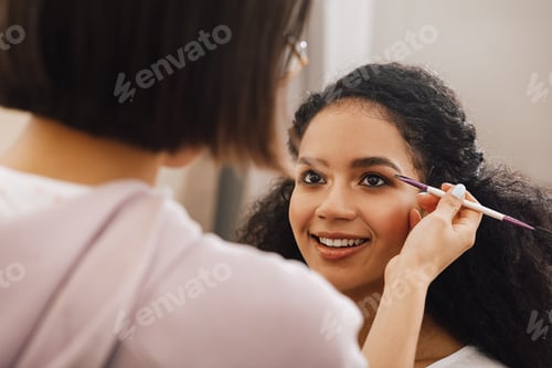 Preview: Makeup artist highlighting eyebrows of a model