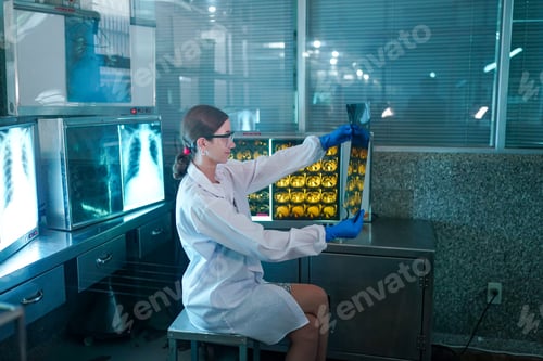 Preview: Portrait of young doctor checking X-Ray in hospital to make diagnosis