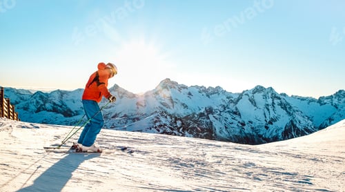Preview: Professional skier athlete skiing at sunset on top of french alps