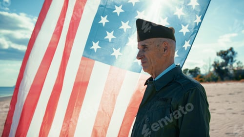 Preview: United States Veteran Looks At The Ocean From The Beach With America Flag