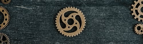 Preview: top view of vintage metal gear in frame on dark wooden background, panoramic shot
