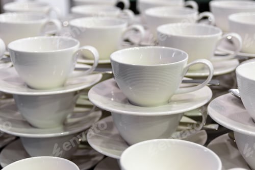 Stacks of White Teacups and Saucers for Service