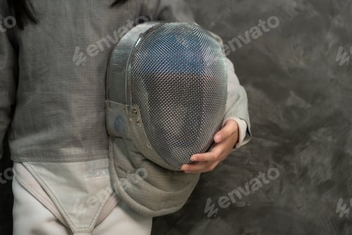 Preview: Before the tournament day, a girl dressed in fencing gear are rehearsing in gym
