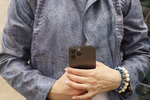 Preview: The girl is holding a phone in her hands