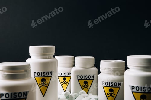 Preview: Selective focus of jars with poison sign and pills isolated on black