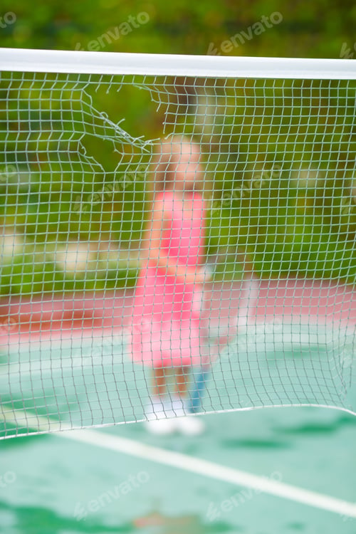 Preview: Little girl playing tennis on the court