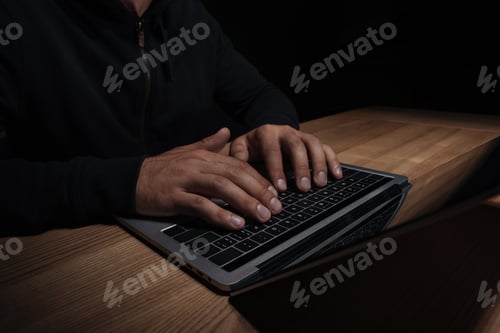 Preview: cropped shot of hacker using laptop, cuber security concept