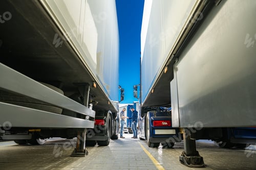 Preview: Group of Trucks Parked in Lot and Their Drivers