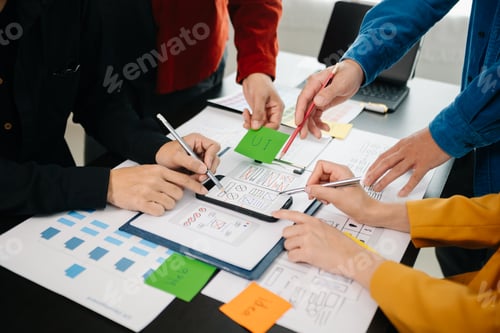 Preview: Close up view of UI developer team brainstorming on their project with laptop,