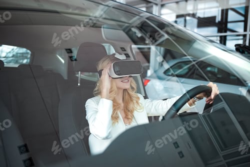 Preview: Pretty woman sitting in a car in 3D glasses of virtual reality
