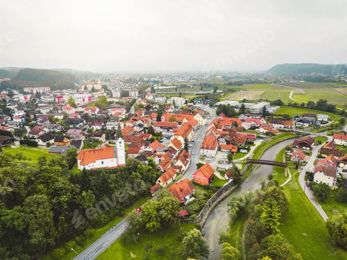Preview: Aerial view of small town in the country side on cloudy day in the autumn