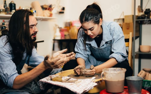 Preview: Craftsman potter making jug of clay on the potter's wheel circle in workshop