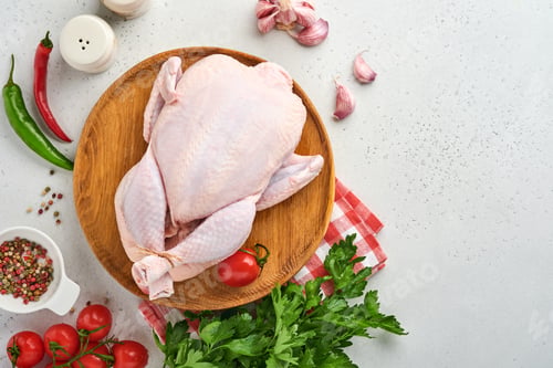 Preview: Whole raw chicken with ingredients for making rose pepper, lemon, thyme, garlic, cherry tomato, sorr