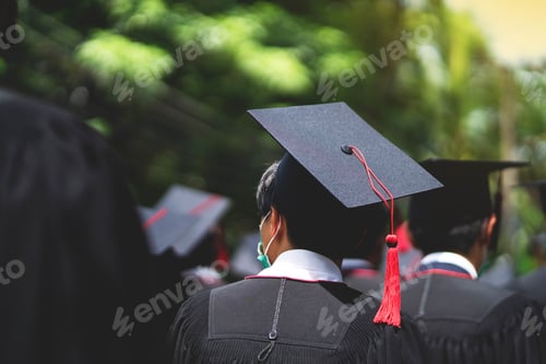 Preview: A group of people wearing black graduation gowns and caps