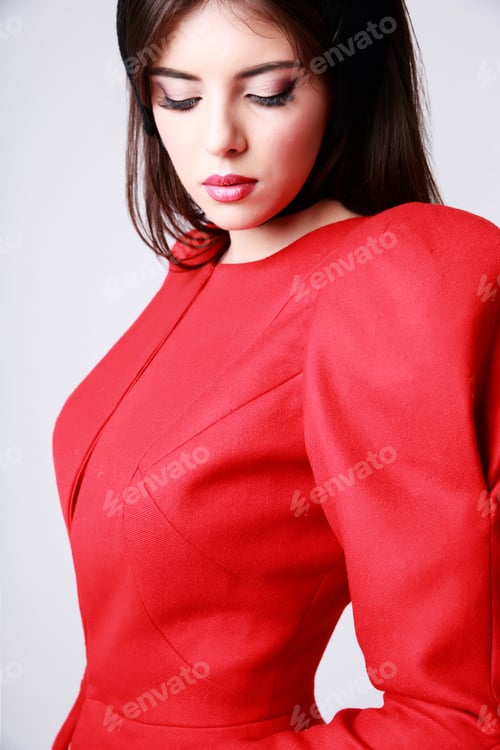 Preview: Closeup portrait of a beautiful woman in red dress