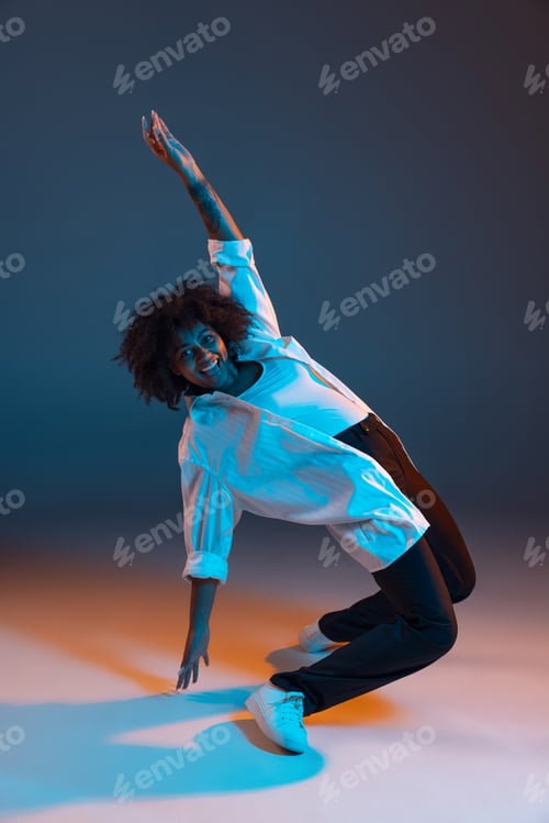 Preview: Full-length portrait of African young girl casual clothes, outfit isolated on dark blue studio