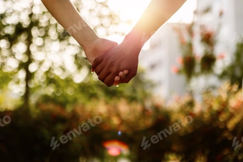 Preview: Two unrecognizable young diverse women holding hands over city background