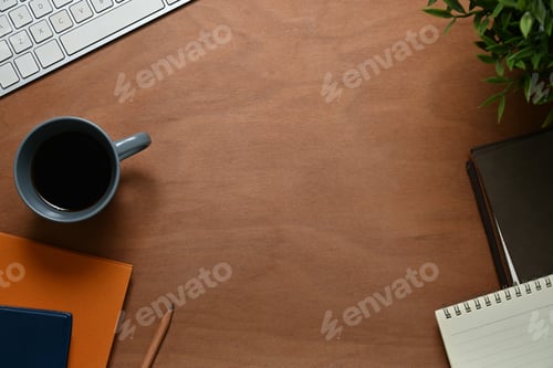 Preview: Wooden desk with cup of coffee, notepad and computer keyboard. Top view, Flat lay