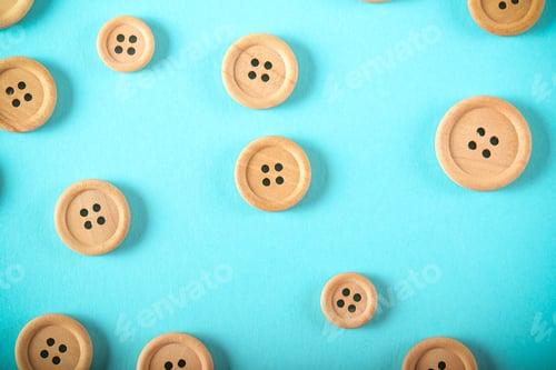 Preview: Wooden Buttons Lie On A Bright Background