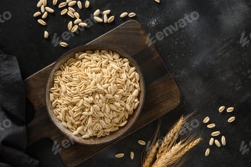 Preview: Dry homemade pasta Cavatelli in plate on black.