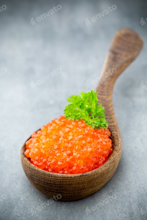 Preview: Salmon caviar with spoon on gray background.
