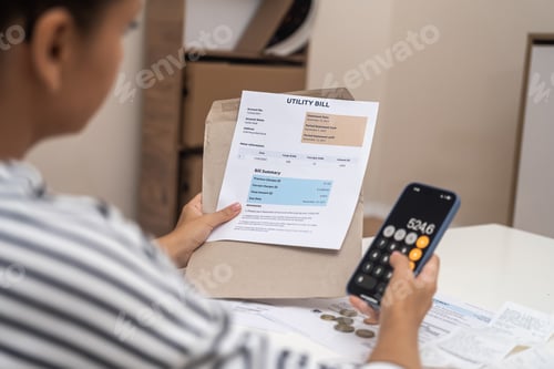 Preview: Lady examines bank accounts with price of utilities for month of living counting on calculator