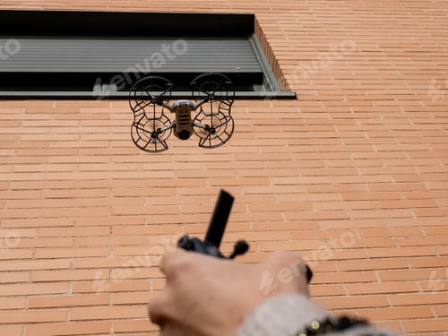 Preview: Soft focus of a drone against a brick facade of a building
