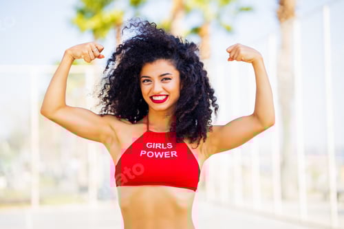 Preview: Smiling Woman Shows Muscles in Urban Environment