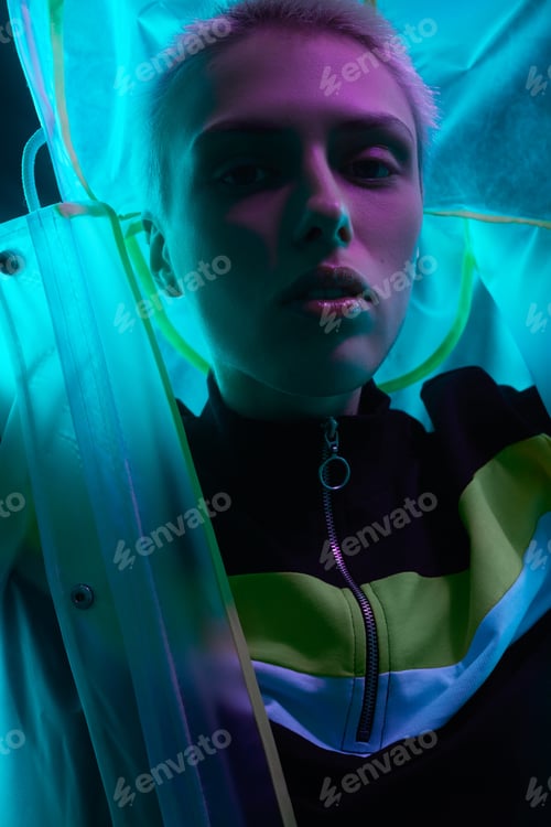 Preview: Futuristic woman in hooded raincoat