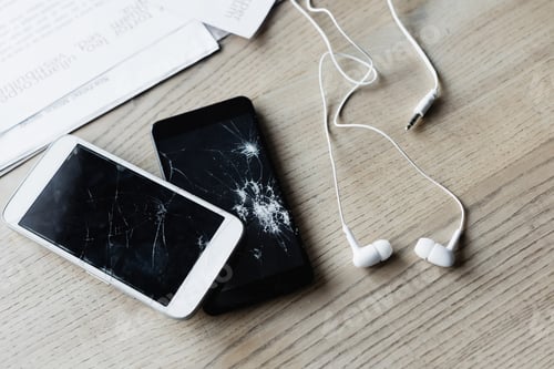 Preview: Top view of earphones and smashed smartphones near documents on wooden background, banner