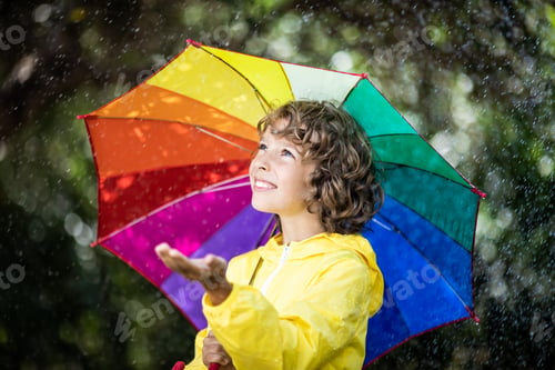Preview: Happy child playing in the rain