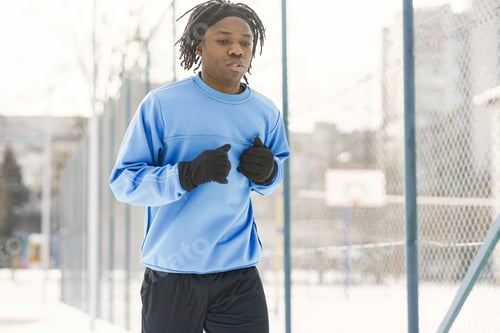 Preview: African american man running on winter day