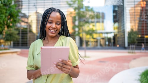 Preview: Smiling businesswoman using tablet in urban financial district