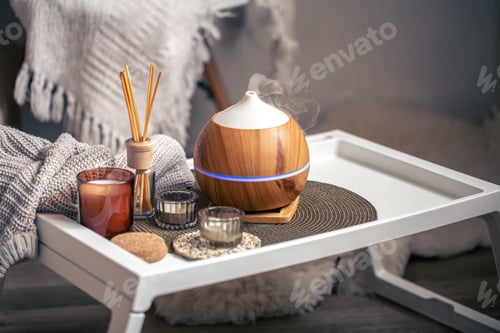 Preview: A cozy composition with an aroma diffuser and candles in a home interior.