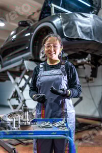 Preview: Female mechanic working on car in auto repair shop