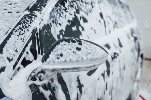 Preview: New modern car in soap parked indoors. Conception of service