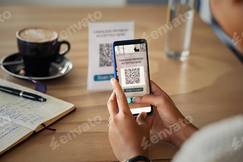 Preview: Woman scanning barcode with phone to pay at cafeteria