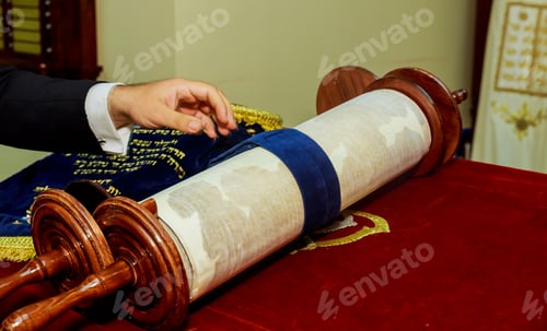 Preview: Hand of boy reading the Jewish Torah at Bar Mitzvah