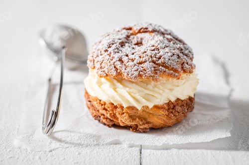 Preview: Sweet and yummy cream puffs with sugar and vanilla cream.