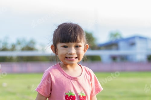 Preview: Portrait of child. Face of smiling Asian girl in head shot. Happy kid.